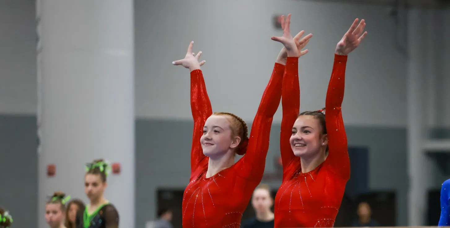 Two Chow's gymnasts salute after a routine at the Winter Classic